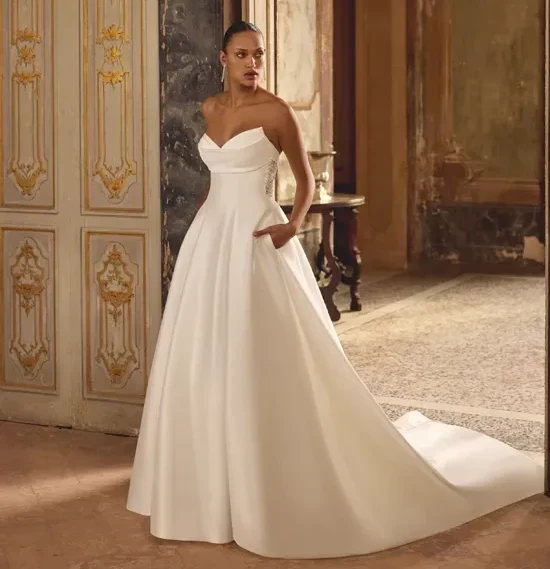 Model wearing a white gown by Justin Alexander